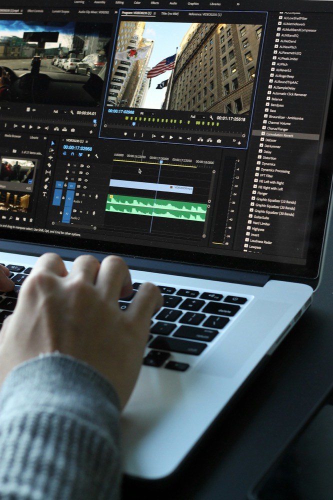 Producing creative for Ganjing World video ads Video editor cutting an advertising clip on a laptop timeline