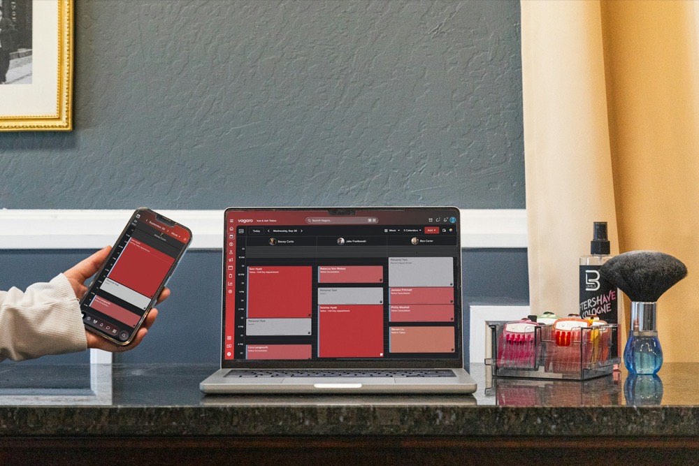 Tooo.vip booking and membership features Laptop on a counter showing a booking management screen next to a phone with the mobile view